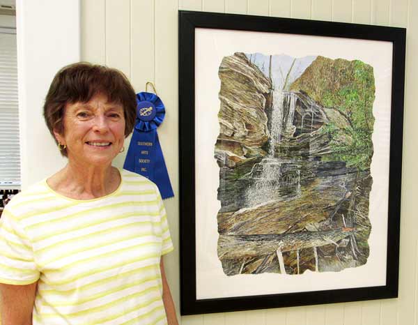 Martha K. Moore and her watercolor of Hanging Rock State Park waterfall, first place winner of Kings Mountain nature painting art show